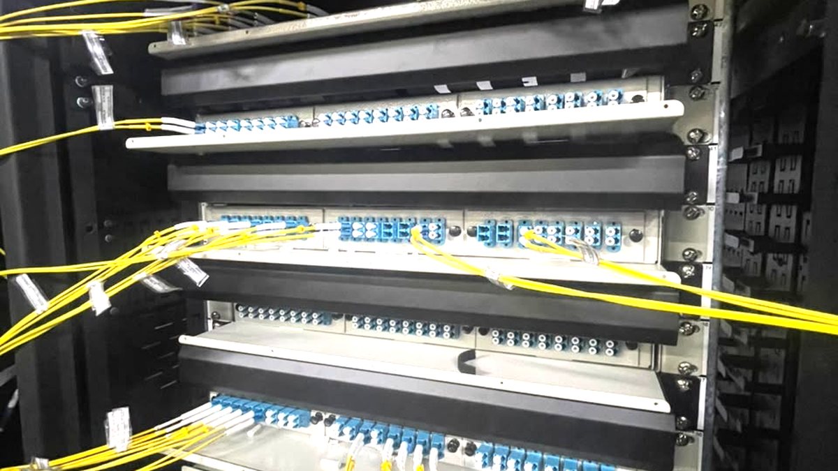 Paneles ópticos montados en bastidor, con adaptadores LC y patchcords monomodo amarillos conectados y ordenados.